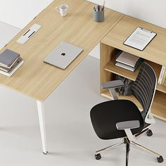 an office desk with a chair and laptop on it