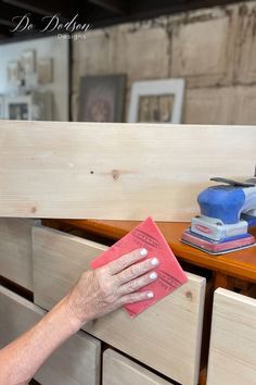 a woman is cleaning drawers with a microfit sponge and a sandpaper pad