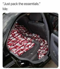 the back seat of a car filled with soda cans