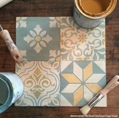 a wooden table topped with paint and a cup of coffee