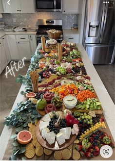 a long table filled with lots of different types of food on top of a kitchen counter