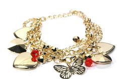 We love the way this charm bracelet sparkles! 3 tier gold tone linked chains dangling pretty heart and butterfly charms along with tiny golden disco ball beads and red crystal beads. A well done piece for a pretty wrist accent. * Length: 7.5 inches with a 2 inch extender Lobster clasp closure Base metal Valentine's Day Gold Chain Charm Bracelet, Gold Chain Charm Bracelet For Valentine's Day, Metal Charm Bracelet With Heart Charm For Party, Gold Charm Bracelet With Lobster Clasp For Party, Heart-shaped Metal Charm Bracelet For Parties, Hearts Butterflies, Butterfly Charm Bracelet, Gold Charm Bracelet, Butterfly Charm