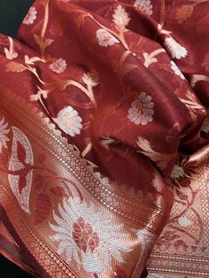 Gorgeous Semi Banarasi Silk Saree in Brick Red color with Copper and Sliver Zari. Floral Jaal Design on the body of the Saree with Grand Pallu. Item : SareeBase Fabric : Semi Banarasi SilkColor : Brick Red Blouse piece : Comes with un-stitched Blouse piece.Blouse material : Semi Banarasi SilkFall & Edging(Yes/No) : Yes Disclaimer -:- Color variation is possible due to various reasons like phone or desktop setting, resolution etc. Please don't hold us responsible. Our aim is to put the exact colo Silver Anarkali For Festivals, Silver Anarkali Traditional Wear For Festivals, Festive Red Katan Silk Anarkali Set, Red Katan Silk Anarkali Set For Diwali, Red Katan Silk Anarkali Set For Wedding, Silver Dupatta For Navratri Festivities, Navratri Festive Silver Dupatta, Red Jamawar Dupatta For Celebration, Festive Silver Dupatta For Navratri