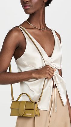 Jacquemus Le Bambino Bag | SHOPBOP Luxury Cream Modern Baguette Bag, Jacquemus 2022 Bag, Luxury Beige Baguette Bag With Handle Drop, Jacquemus Le Chiquito Noeud Leather Shoulder Bag, Jacquemus Le Bambino Tote Bag, Jacquemus Bag Le Grand Chiquito, Jacquemus Mini Bags, Luxury Cream Formal Bucket Bag, Jacquemus Le Bambino Mini Bag