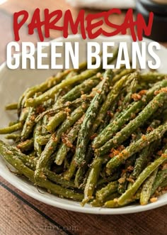 green beans on a white plate with parmesan sprinkles and seasoning