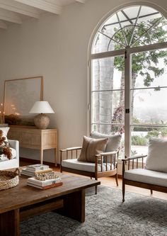 a living room filled with furniture and a large window