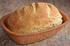 a loaf of bread in a brown bowl