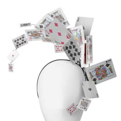 a white mannequin head with playing cards on it