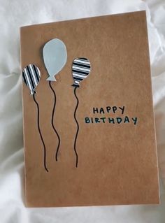 a birthday card with balloons on it and the words happy birthday written in black ink