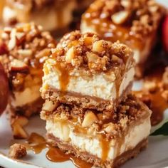 three pieces of dessert sitting on top of a white plate next to an apple and another piece of pie