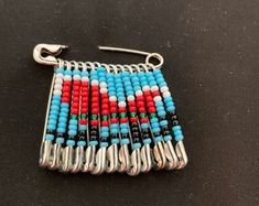 the beaded earrings are made with beads and metal hooks on a black tablecloth