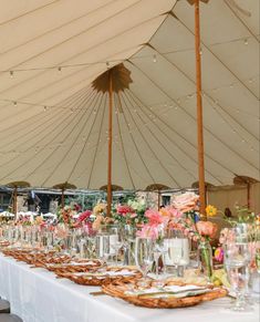 a long table is set up under a large tent