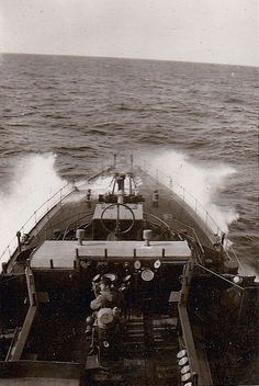 an old black and white photo of a boat in the ocean