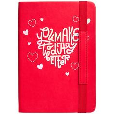 a red notebook with white lettering and hearts on the cover, in front of a white background