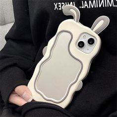 a person holding a cell phone case in their hand with an animal design on it