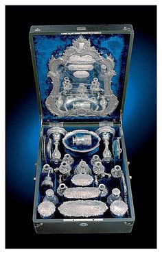 an ornately decorated glass box with silverware in it