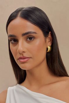 Refine your radiance. The AMELIA Textured Hoop Earrings offer a blend of timeless sophistication and contemporary design. Featuring a post stud for a secure and comfortable fit, these earrings are crafted in a half-hoop shape that elegantly frames the ear. The horizontal ribbed detailing adds a dynamic texture, enhancing the rounded silhouette. Plated in 18K gold, the Amelia Hoops exude a luxurious glow, making them a versatile accessory that effortlessly transitions from everyday wear to specia Modern Semi-circle Earrings For Everyday, Elegant Semi-circle Hoop Earrings As Gift, Modern Semi-circle Earrings For Everyday Wear, Workwear Capsule Wardrobe, Workwear Capsule, Capsule Wardrobe Basics, European Summer Outfits, Tie Maxi Dress, Maxi Dress Sale