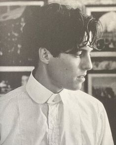 black and white photograph of a young man with short hair wearing a shirt and tie