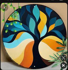 an image of a tree painted on a round wall hanging ornament in the shape of a circle