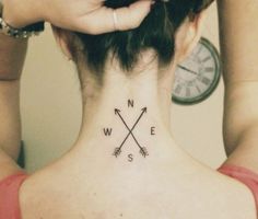 a woman with a tattoo on her neck has an arrow in the center and two arrows at the bottom