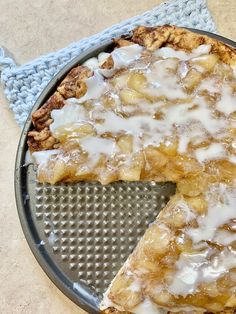 a pie with white icing sitting on top of a pan