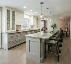 a large kitchen with an island in the middle and lots of counter space on one side