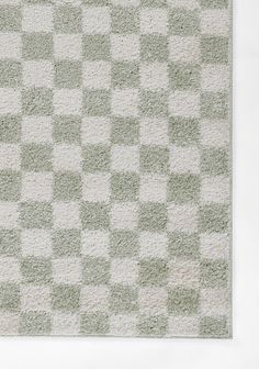 a green and white rug with squares on it