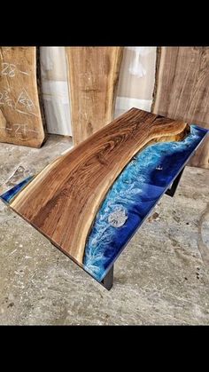 a wooden table with blue and brown wood inlayed to it's surface