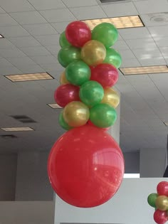 some balloons are hanging from the ceiling in an office