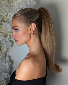 Rachel | Calgary Bridal Hair on Instagram: "Sleek Barbie Pony for the Feed🫶🏻  Chic, Secure, and oh so Snatched thanks to…  @kenraprofessional texturizing Taffy  @schwarzkopfpro Osis 2 and powder  And @moroccanoilpro texturizing spray   The go to Rehearsal Dinner or Reception Party hair for your 2024 wedding 💍  Accessorized with @joannabisleydesigns  earrings  Model (the stunning) @julia.vlodova   On the new RJStyles floral back drop 🤤  #yyc #yycbride #yychair #yycbride #albertabride #albertawedding #haireducation #canadianhairstylist #ponytail #oneshot #btconeshot24_specialeventstyling #beyondtheponytail #weddinghairinspo #weddinghairideas" Wedding Guest Hair High Ponytail, Slick Ponytail Wedding Hair, Ponytail Wedding Guest Hairstyles, Slick Ponytail Updo, Bridal Ponytail With Bow, Blowout Hair Ponytail, Event Ponytail Hairstyles, Slick Bridesmaid Hair, Bridal Hair High Ponytail