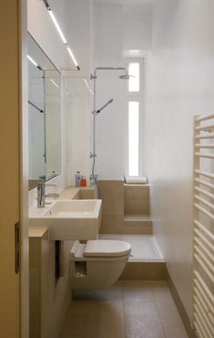 a bathroom with a toilet, sink and bathtub