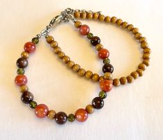 Beautiful handmade double strand bracelet. Made up with Orange and brown rivershell beads, wood beads.  Measures 7.75" long with lobster claw closure. 2" extension. Comes in a gift box. Strings are reenforced with end enforcers for less chance of breaking from wear. Brown Polished Beaded Bracelets As Gift, Brown Beaded Bracelet With Gemstones For Gift, Brown Gemstone Beads Bracelet For Gift, Brown Gemstone Beaded Bracelets Gift, Brown Gemstone Beaded Bracelet For Gift, Gift Brown Beaded Bracelets With Gemstone, Brown Wooden Beads Bracelets Gift, Brown Beaded Bracelets With Colorful Beads For Gift, Brown Beaded Bracelets With Round Beads For Gift