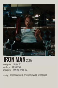 the iron man movie poster is shown in black and white, with a man sitting on a couch