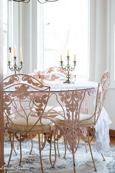 a dining room table with chairs and a chandelier