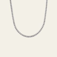 Everyone needs a perfect diamond tennis necklace in their accessory rotation. This 20-inch diamond line necklace with 15.50 carats of diamonds is just the piece to add to your wardrobe. You can dress it for a formal black-tie event or keep it super casual by layering with a colorful, beaded chain. This unisex piece will truly become your jewelry MVP. Details18K White Gold160 Round Cut Diamonds15.50 CaratsDiamonds Weigh Approximately 0.10 Carats EachLength: 20 Inches Diamond Tennis Necklace, Tennis Necklace, Black Tie Event, Watch Necklace, Round Cut Diamond, Ring Bracelet, Beaded Chain, Black Tie, Earring Necklace