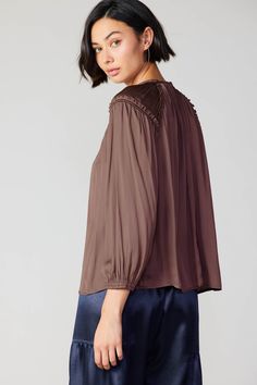 Done in an earthy shade, this blouse is cut for a loose, flowing fit accentuated by soft gathers at the neckline and little ruffles edged with picot stitching. •Round neckline •Long sleeves •Ruffled cuffs with button closure •Loop-button keyhole at back Item number 2230015100% Polyester Imported Chic Brown Tops For Daywear, Fall Viscose Blouse With Ruffles, Billowy Ruffled Blouse For Fall, Fall Ruffled Billowy Blouse, Feminine Brown Tops For Fall, Fall Billowy Ruffled Blouse, Fall Ruffle Viscose Tops, Fall Viscose Ruffle Top, Flowy Brown Blouse For Fall