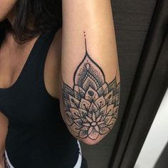 a woman's arm with a tattoo on it and an image of a flower