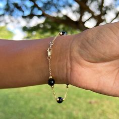 Gift yourself a unique gem that is only from Hawaiʻi. The Hawaiian Black Coral Bracelet in Gold features high-polished and sustainably harvested Hawaiian black coral beads with accenting gold beads and a gold chain. The dramatic contrast will go beautifully with various looks. Bracelet 14k Yellow Gold 8-8.9mm Hawaiian Black Coral Beads Gold Beads Approximately 7.5"-8" in length Locally Made in Hawaiʻi Forever Guarantee (Lifetime Warranty on the life of the piece) Free Shipping on USA Orders $100 Luxury Black Jewelry With Gemstone Beads, Black Spinel Round Beads Jewelry For Gifts, Gift Black Spinel Round Bead Jewelry, Elegant Black Jewelry With Gold Beads, Luxury Black Polished Beads Jewelry, Luxury Black Polished Bead Jewelry, Luxury Beaded Onyx Jewelry, Luxury Black Jewelry With Polished Beads, Elegant Onyx Beaded Bracelets With Polished Beads