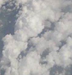 the view from an airplane looking down at clouds