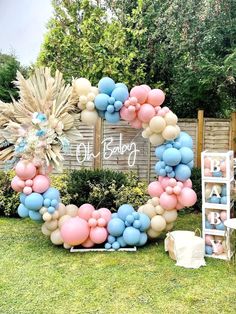 a large balloon wreath with blue, pink and white balloons in the shape of a heart