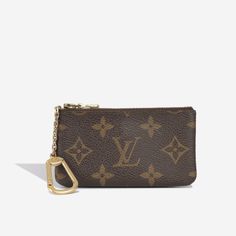 The ideal multi-purpose accessory to carry with you wherever you go. Carefully crafted from Louis Vuitton's signature monogram canvas and gold tone hardware, this little zip pouch will come in handy way more than you think. It can be used as a key ring, to store loose change or to keep your house keys in. Sleek, stylish and sophisticated, this understated but luxurious piece is a must-have for any accessories collection. SPL Exterior Brown monogram canvas Gold tone hardware Zip close Gold clip attachment 1993 production Good vintage condition - tarnishing to the hardware and fading of the canvas. Interior Brown leather interior One compartment Good vintage condition - some interior wear SPL Height 6.5cm Width 12cm Depth 0.5cm Luxury Monogram Canvas Wallets, Brown Rectangular Coin Purse With Key Clip, Luxury Brown Women's Wallet On Chain, Luxury Gold Wallet With Gold-tone Hardware, Brown Wallet With Zipper Pouch For On-the-go, Louis Vuitton Key Pouch, Louis Vuttion Key Pouch, Key Pouch, House Keys