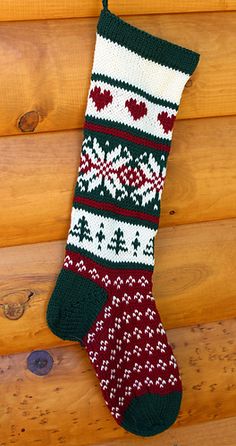 a knitted christmas stocking hanging on a wooden wall