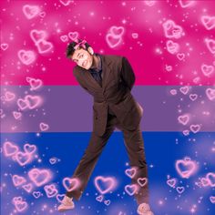 a man in a suit and bow tie is dancing with hearts all over the background