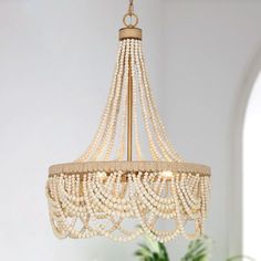 a chandelier with pearls hanging from the ceiling