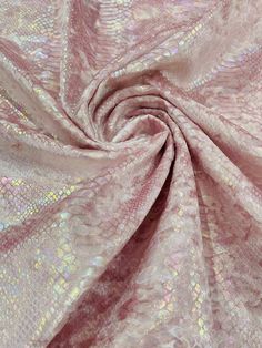 a pink and silver fabric with metallic foil on it's edges, as well as the