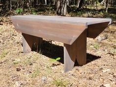 a wooden bench sitting in the middle of a forest