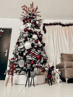 a christmas tree decorated with red, white and black ornaments