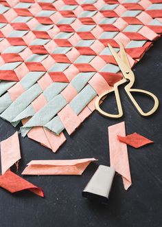 a pair of scissors sitting on top of a piece of paper next to some tape