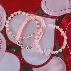 the beads are attached to the heart - shaped object on the table top, with other hearts around it