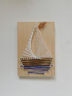 a piece of wood that has some knitting needles on it